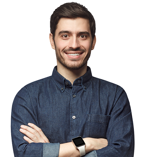 Schneider & Company - Confident young man with a friendly smile, wearing a denim shirt and smartwatch, standing with arms crossed.