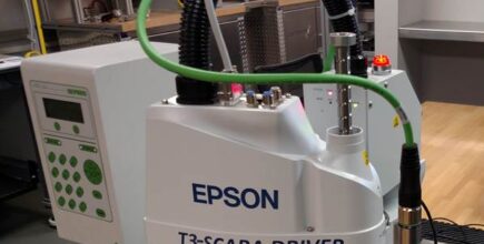 Schneider & Company - A Deprag Epson T3-SCARA driver industrial robot performing a task or demonstration on a workbench.
