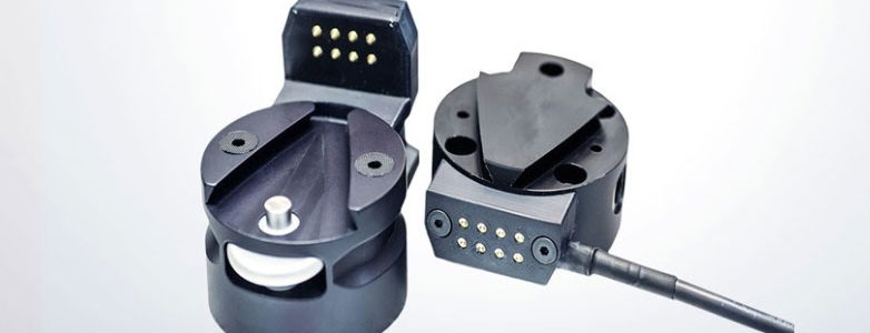 Schneider & Company - Two modern, black multi-pin connectors, one with its cover opened to reveal the metallic pins, against a clean, white background.