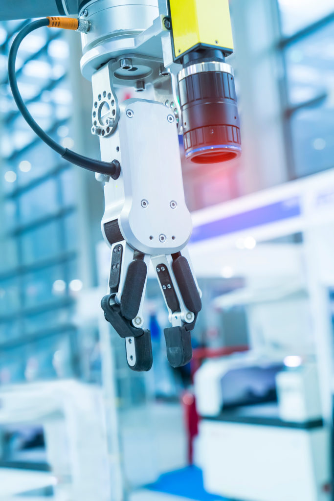 a macro shot of a robotic arm that's using an infrared camera to capture images during a manufacturing process